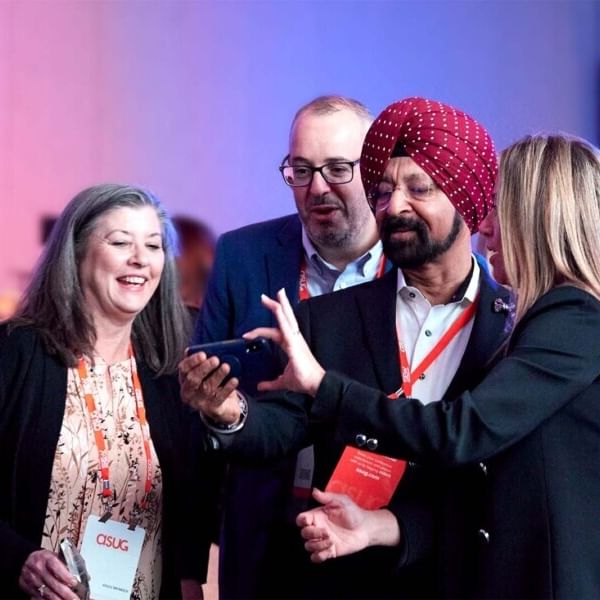 A group of ASUG members taking a photo together at our events.